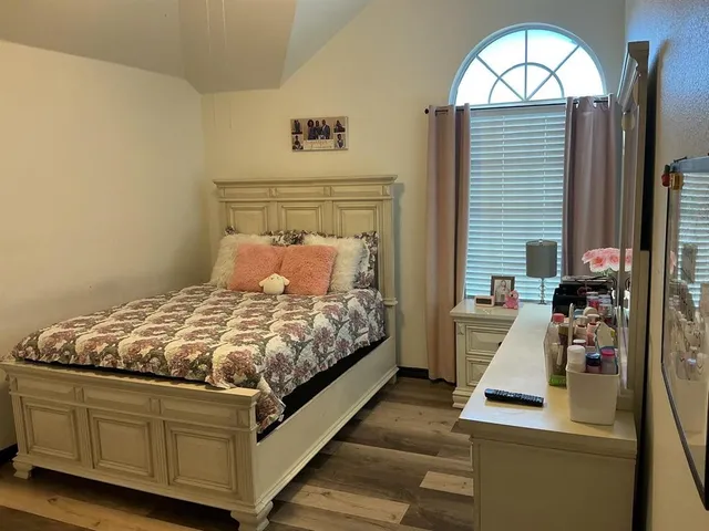 a bedroom with bed and a window