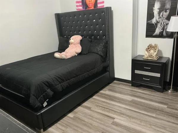 a bedroom with two beds and a mirror