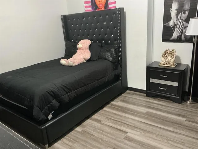 a bedroom with two beds and a mirror