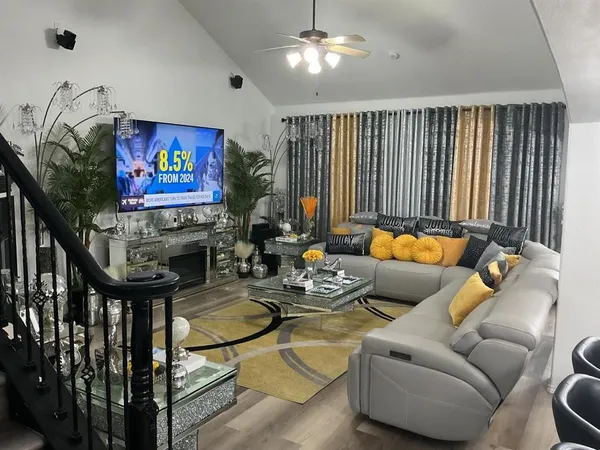 a outdoor living space with furniture and a flat screen tv