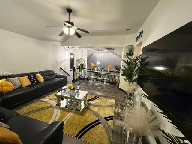 a living room with furniture and a chandelier