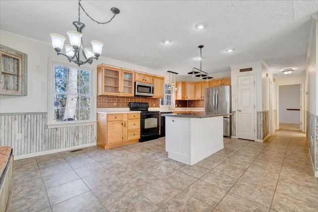 a kitchen with stainless steel appliances granite countertop a sink and a granite counter tops