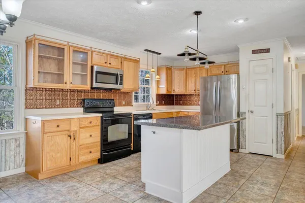 a kitchen with stainless steel appliances granite countertop a stove and a sink