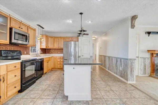 an empty room with window and ceiling fan