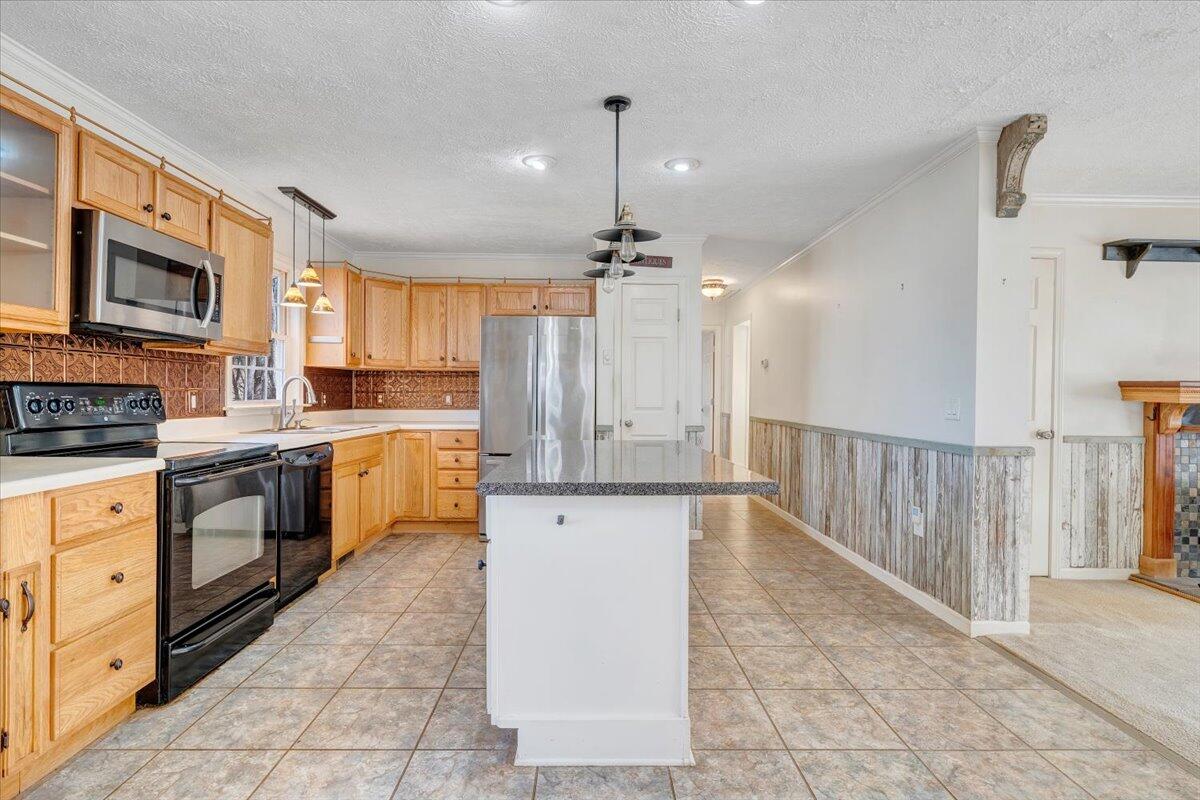 365 Isolane Road Callaway, VA 24067 - Photo 15 of 104 a kitchen with stainless steel appliances granite countertop a stove top oven a sink dishwasher and a refrigerator with the cabinets