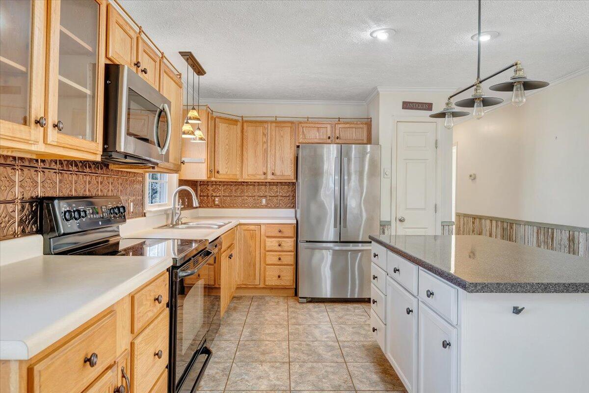 365 Isolane Road Callaway, VA 24067 - Photo 16 of 104 a kitchen with stainless steel appliances granite countertop a refrigerator a stove and a sink