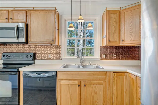 a bathroom with a granite countertop sink toilet mirror vanity and shower