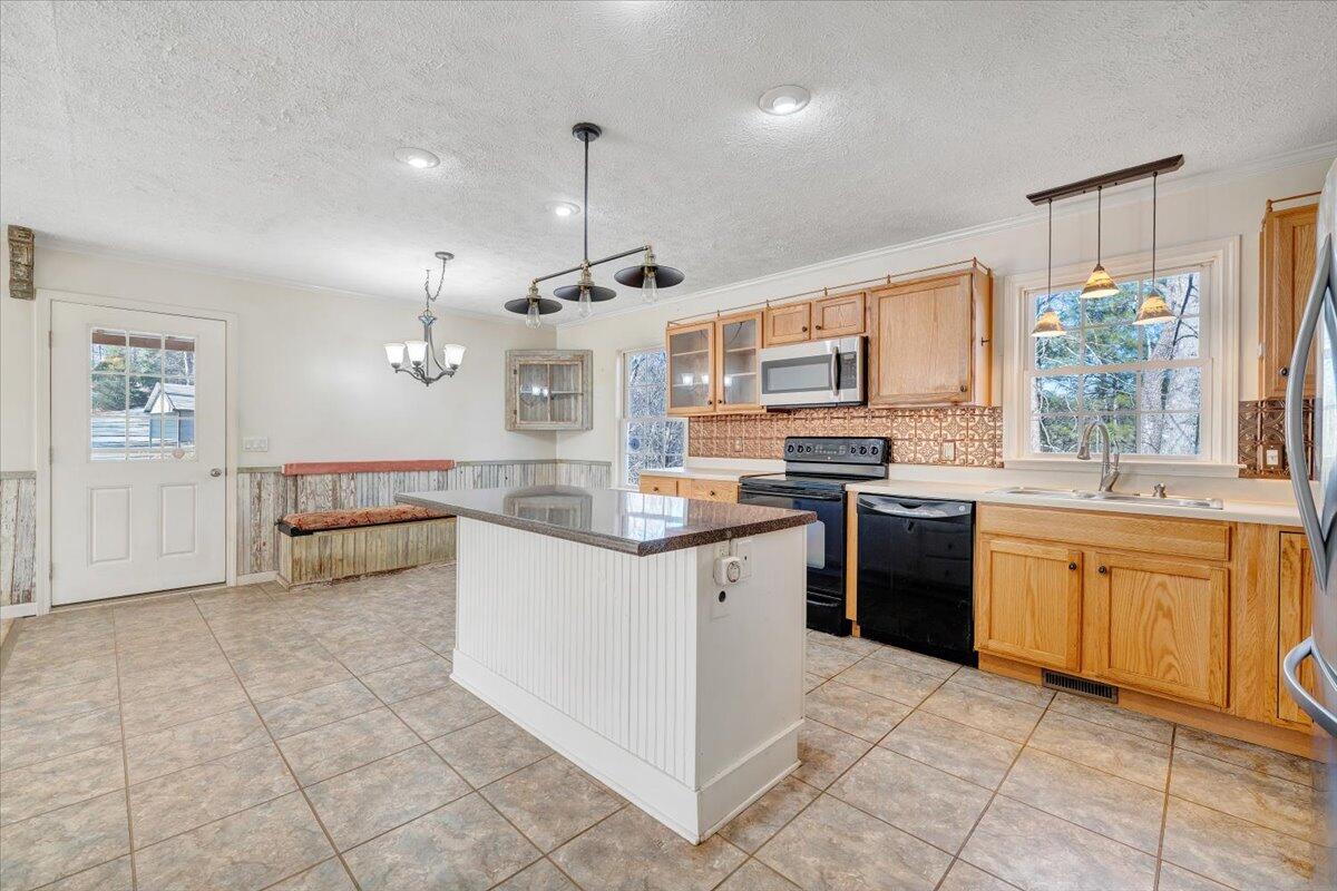 365 Isolane Road Callaway, VA 24067 - Photo 18 of 104 a kitchen with stainless steel appliances granite countertop a stove and a sink