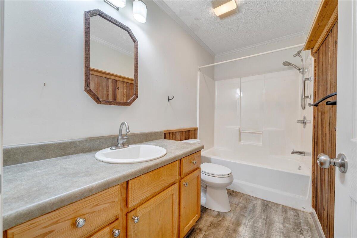 365 Isolane Road Callaway, VA 24067 - Photo 25 of 104 a bathroom with a granite countertop sink toilet mirror vanity and shower