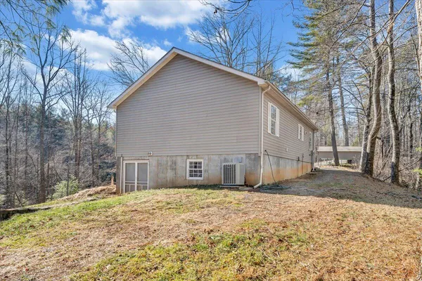 a kitchen with stainless steel appliances granite countertop a stove a sink and a granite counter tops with white cabinets