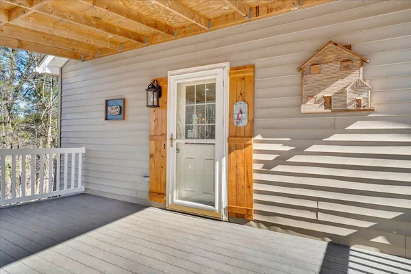 a kitchen with stainless steel appliances granite countertop a refrigerator oven a sink dishwasher and white cabinets with wooden floor