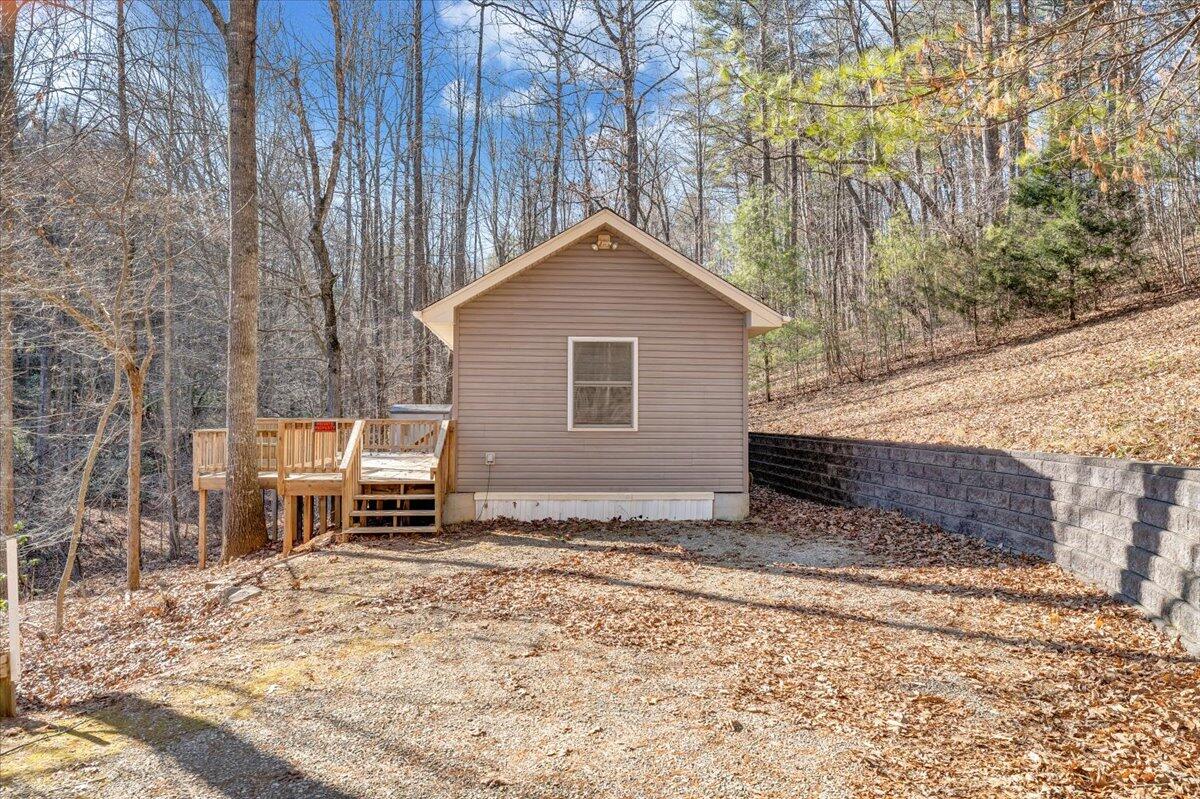 365 Isolane Road Callaway, VA 24067 - Photo 78 of 104 a backyard of a house with a large tree and wooden fence