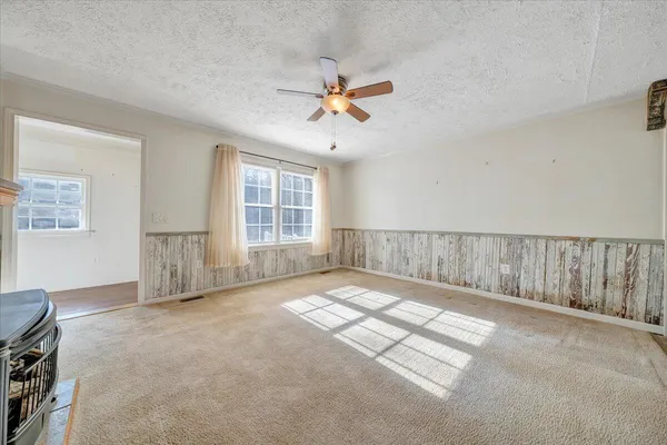 a kitchen with stainless steel appliances granite countertop a stove top oven a sink dishwasher and a refrigerator with the cabinets