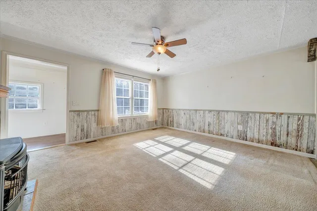 a kitchen with stainless steel appliances granite countertop a stove top oven a sink dishwasher and a refrigerator with the cabinets