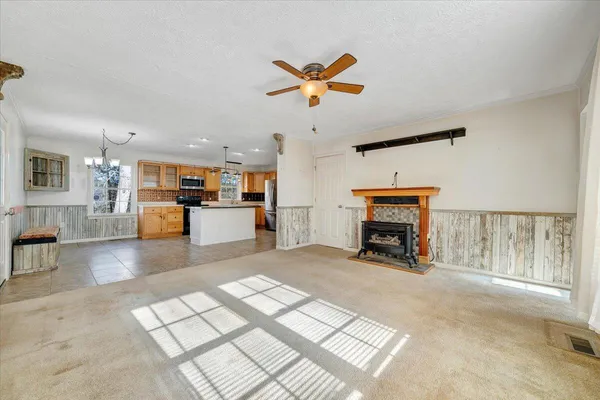 a kitchen with stainless steel appliances granite countertop a refrigerator a stove and a sink