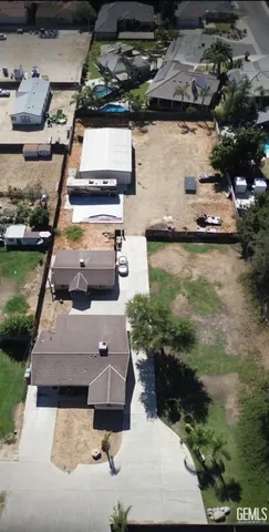 an aerial view of a house with a garden and lake view