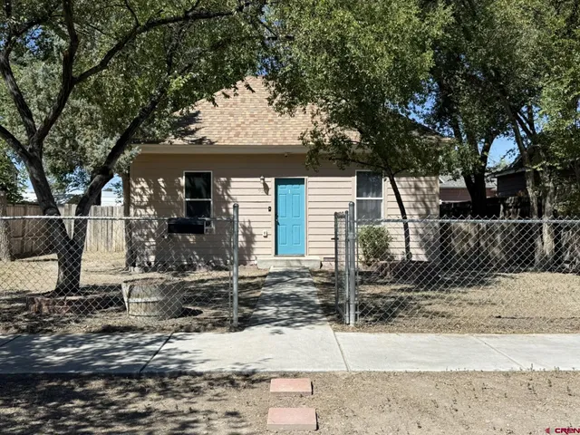 a front view of a house with trees