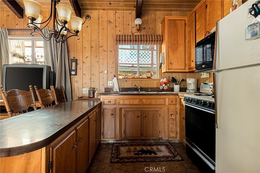 1164 Bear Springs Road Rimforest, CA 92378 - Photo 11 of 18 a kitchen with a sink stove and microwave