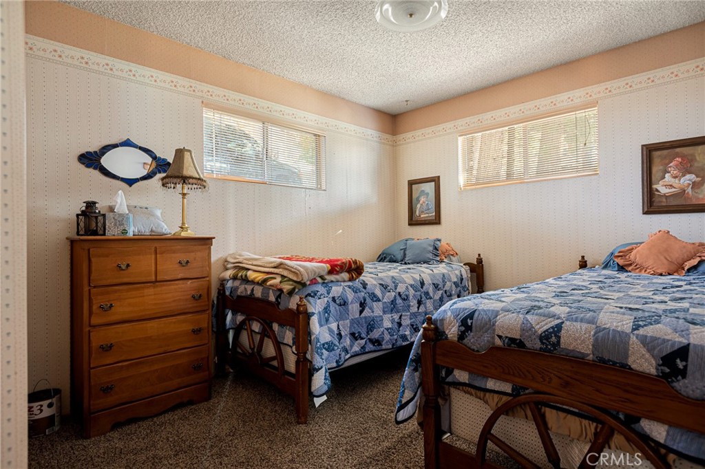 1164 Bear Springs Road Rimforest, CA 92378 - Photo 17 of 18 a bedroom with two beds and painting on the wall