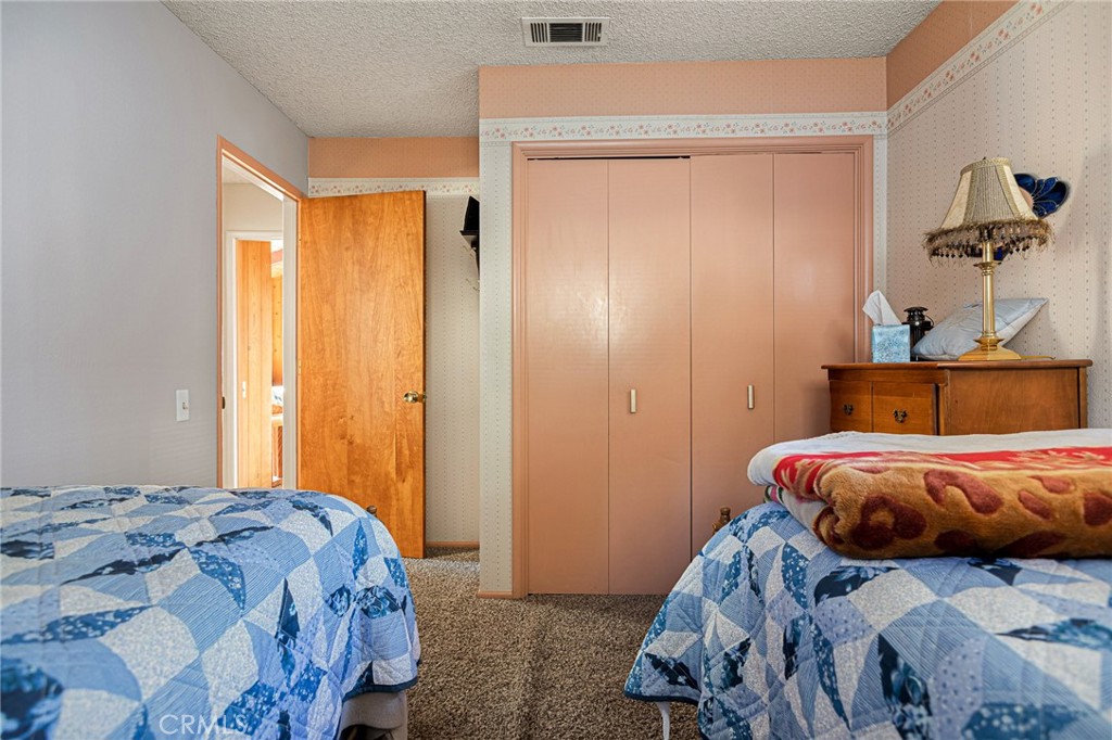 1164 Bear Springs Road Rimforest, CA 92378 - Photo 18 of 18 a bedroom with a bed and a window