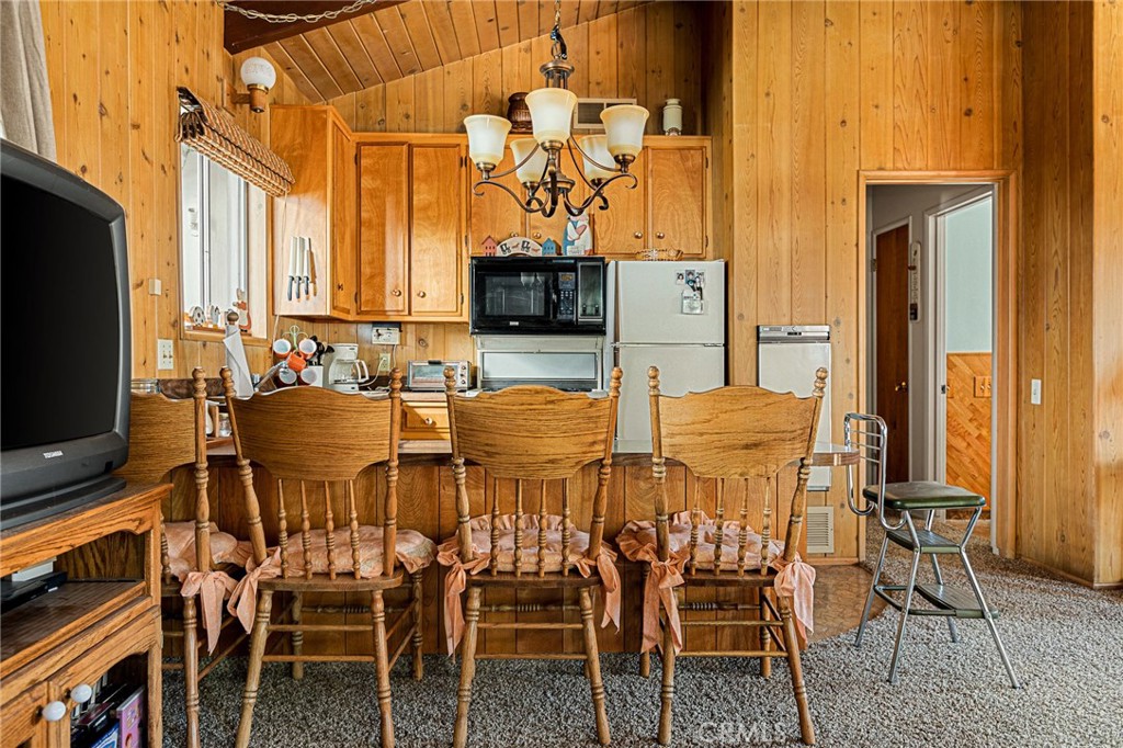 1164 Bear Springs Road Rimforest, CA 92378 - Photo 6 of 18 a view of a dining room with furniture and wooden floor