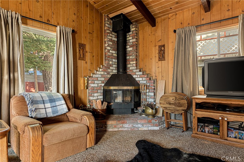 1164 Bear Springs Road Rimforest, CA 92378 - Photo 9 of 18 a living room with furniture a fireplace and a flat screen tv