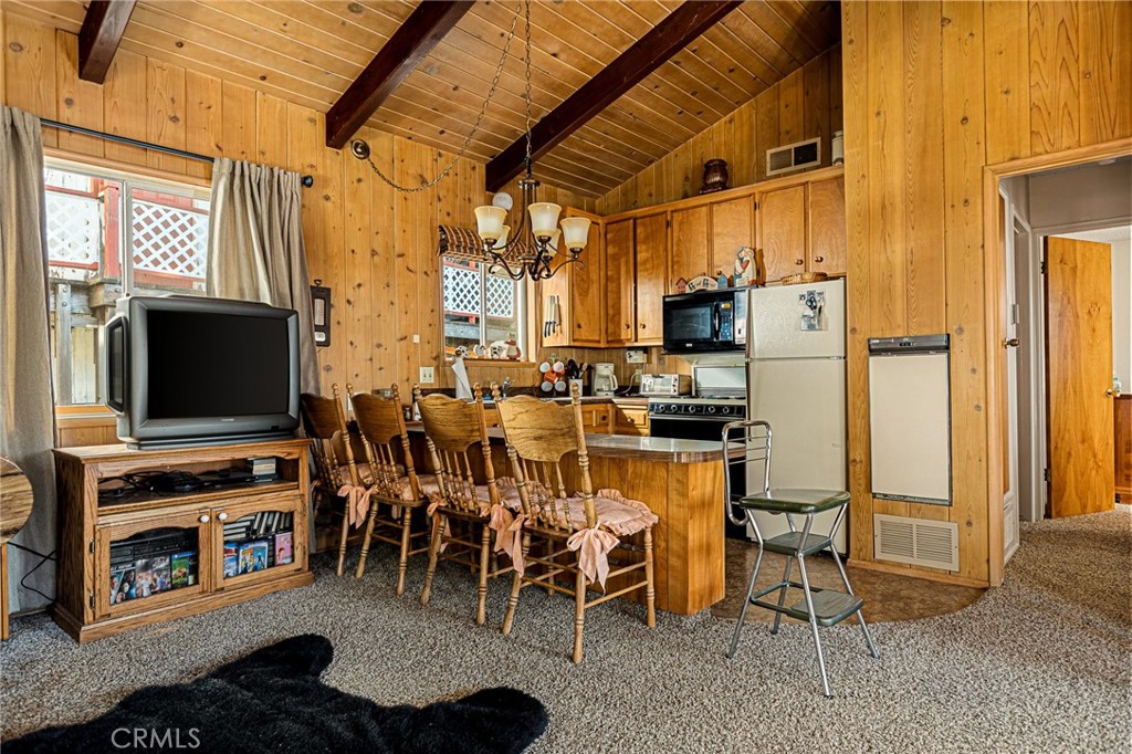 1164 Bear Springs Road Rimforest, CA 92378 - Photo 10 of 18 a living room with stainless steel appliances furniture a fireplace and a flat screen tv