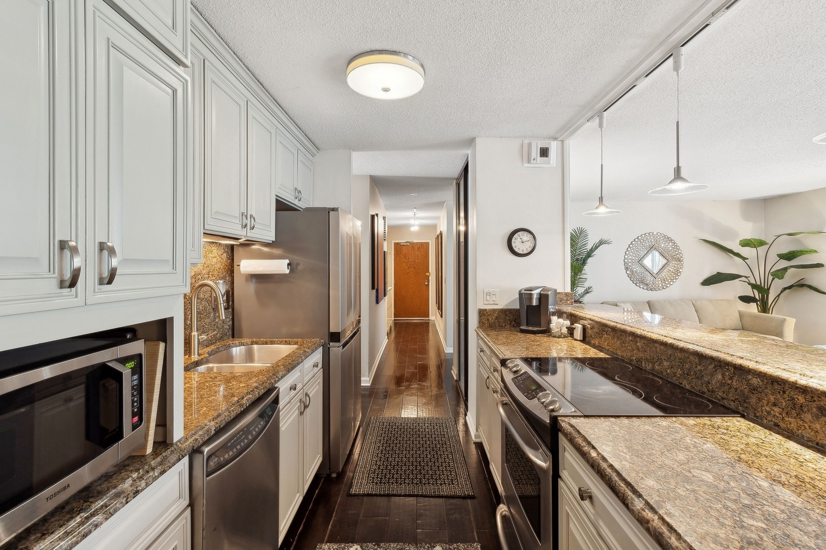 71 East Division Street, Unit 401 Chicago, IL 60611 - Photo 9 of 21 a kitchen with a sink stove and refrigerator