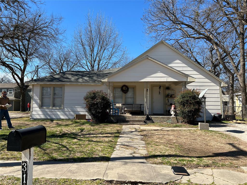 View of front of house featuring fence and a porch