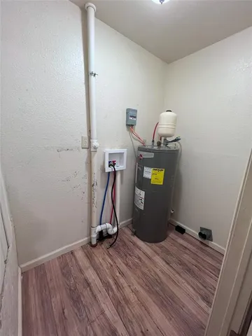 a view of a room with wooden floor and furniture