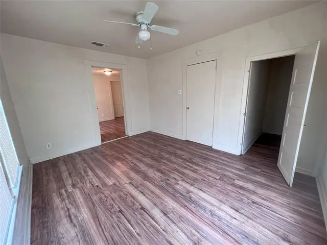 wooden floor in an empty room with a closet