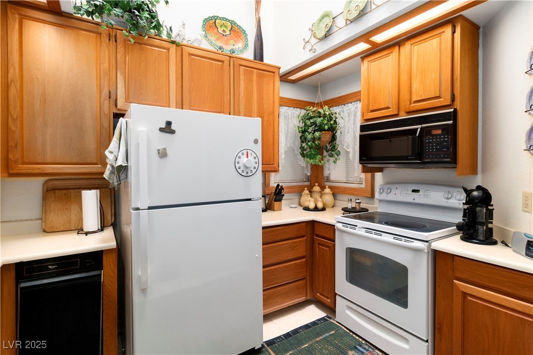 3859 Desert Marina Drive, Unit 257 Laughlin, NV 89029 - Photo 15 of 89 Kitchen featuring white appliances, light countert