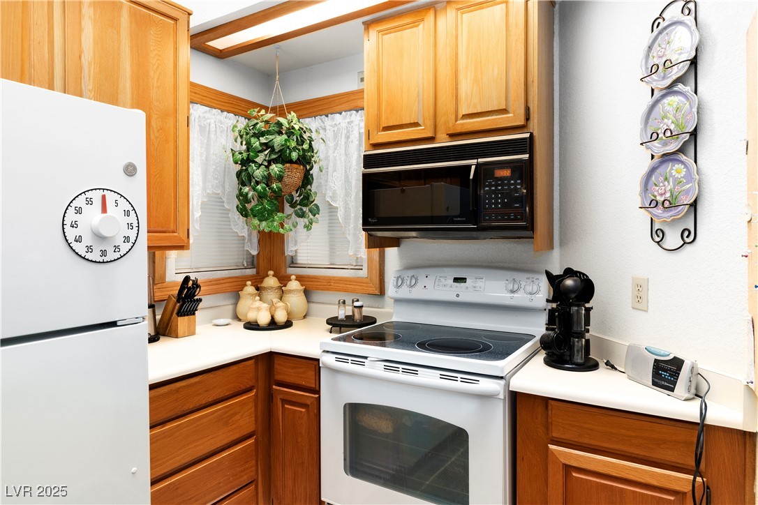 3859 Desert Marina Drive, Unit 257 Laughlin, NV 89029 - Photo 16 of 89 Kitchen featuring white appliances, light countert
