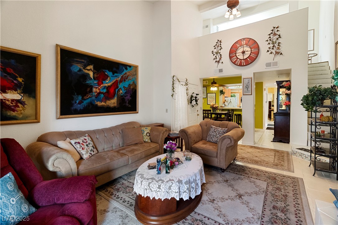 3859 Desert Marina Drive, Unit 257 Laughlin, NV 89029 - Photo 9 of 89 Tiled living room with stairs and a high ceiling