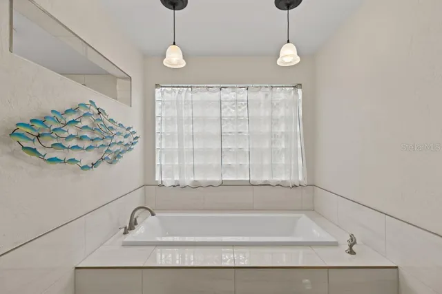 a bathroom with a granite countertop double vanity sink mirror and