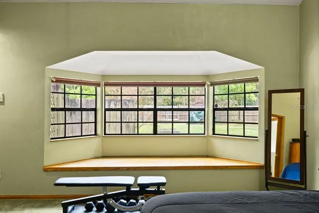 a bedroom with a large bed and a window