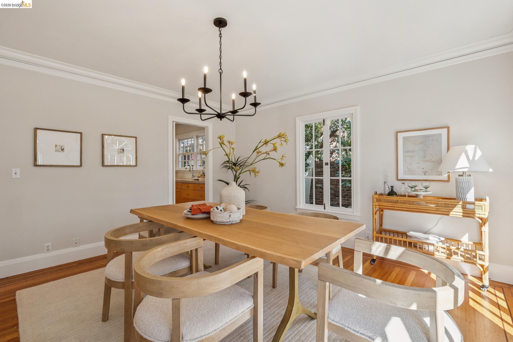 900 Rosemount Road Oakland, CA 94610 - Photo 27 of 59 a view of a dining room with furniture a chandelier and wooden floor