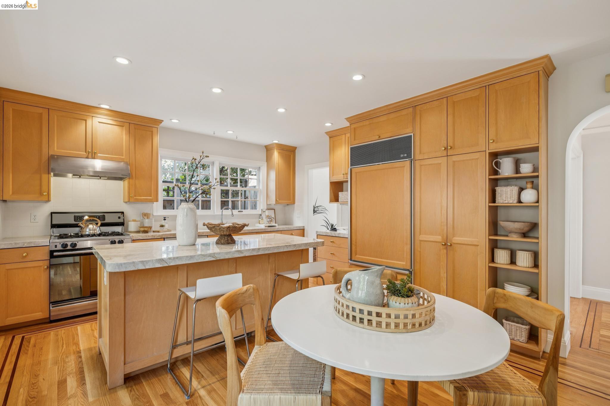 900 Rosemount Road Oakland, CA 94610 - Photo 34 of 59 a kitchen with stainless steel appliances granite countertop a stove a sink a dining table and chairs