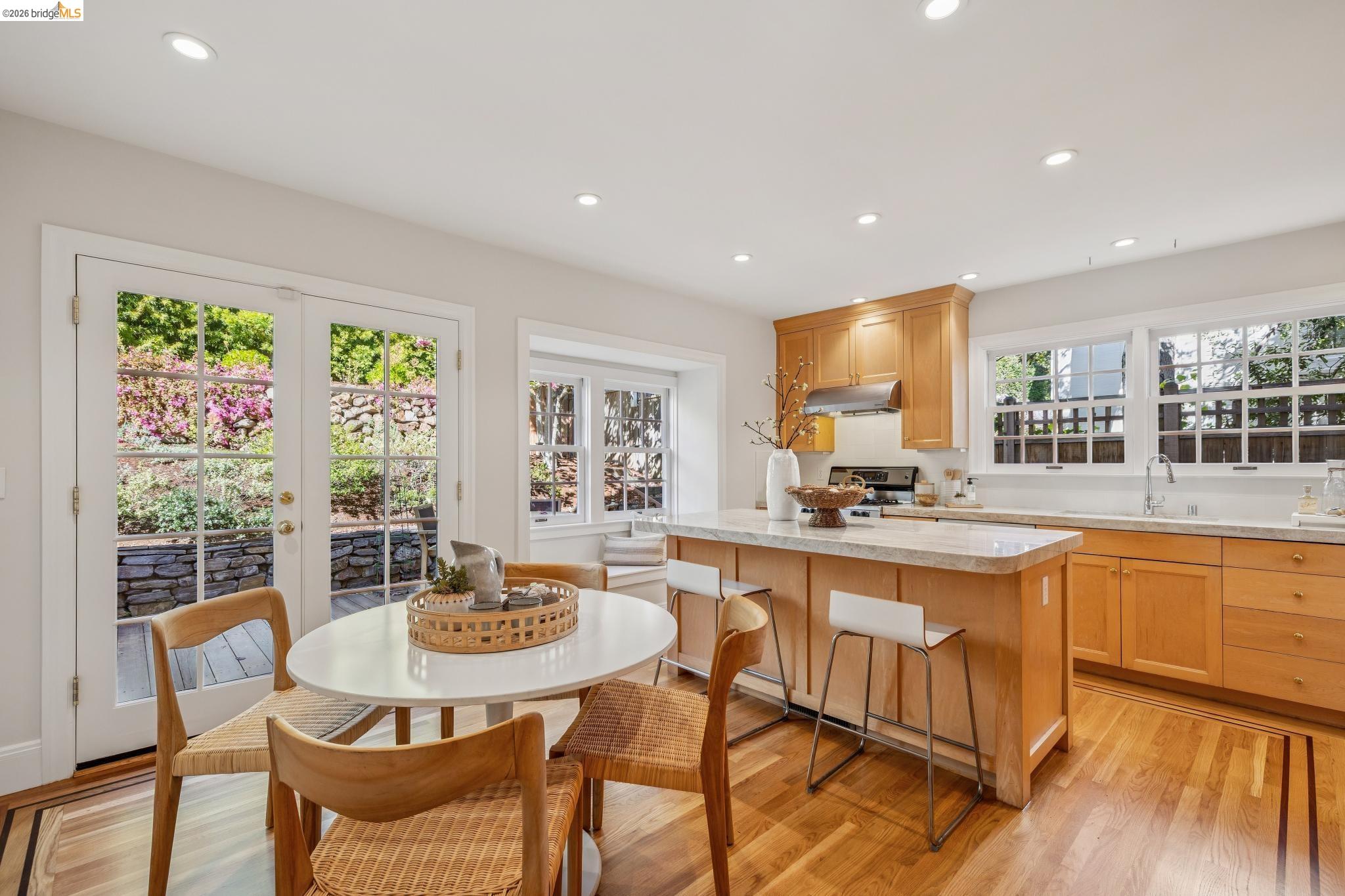 900 Rosemount Road Oakland, CA 94610 - Photo 35 of 59 a kitchen with stainless steel appliances granite countertop a stove a sink a dining table and chairs