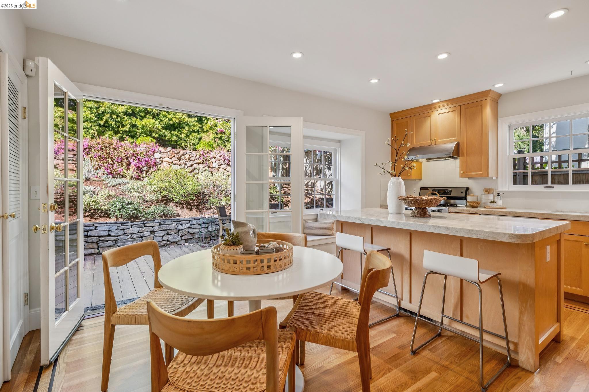 900 Rosemount Road Oakland, CA 94610 - Photo 36 of 59 a dining room with furniture a rug and a large window