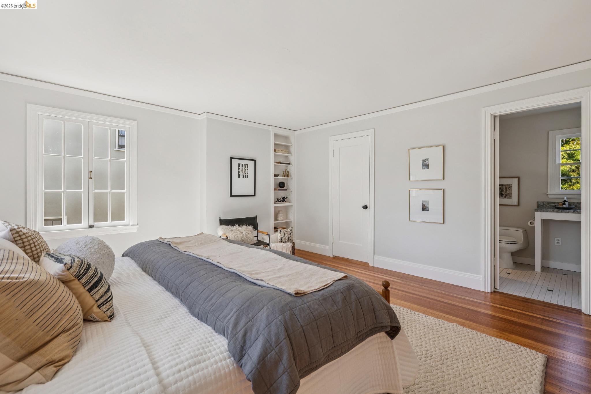 900 Rosemount Road Oakland, CA 94610 - Photo 42 of 59 a bedroom with a large bed and wooden floor