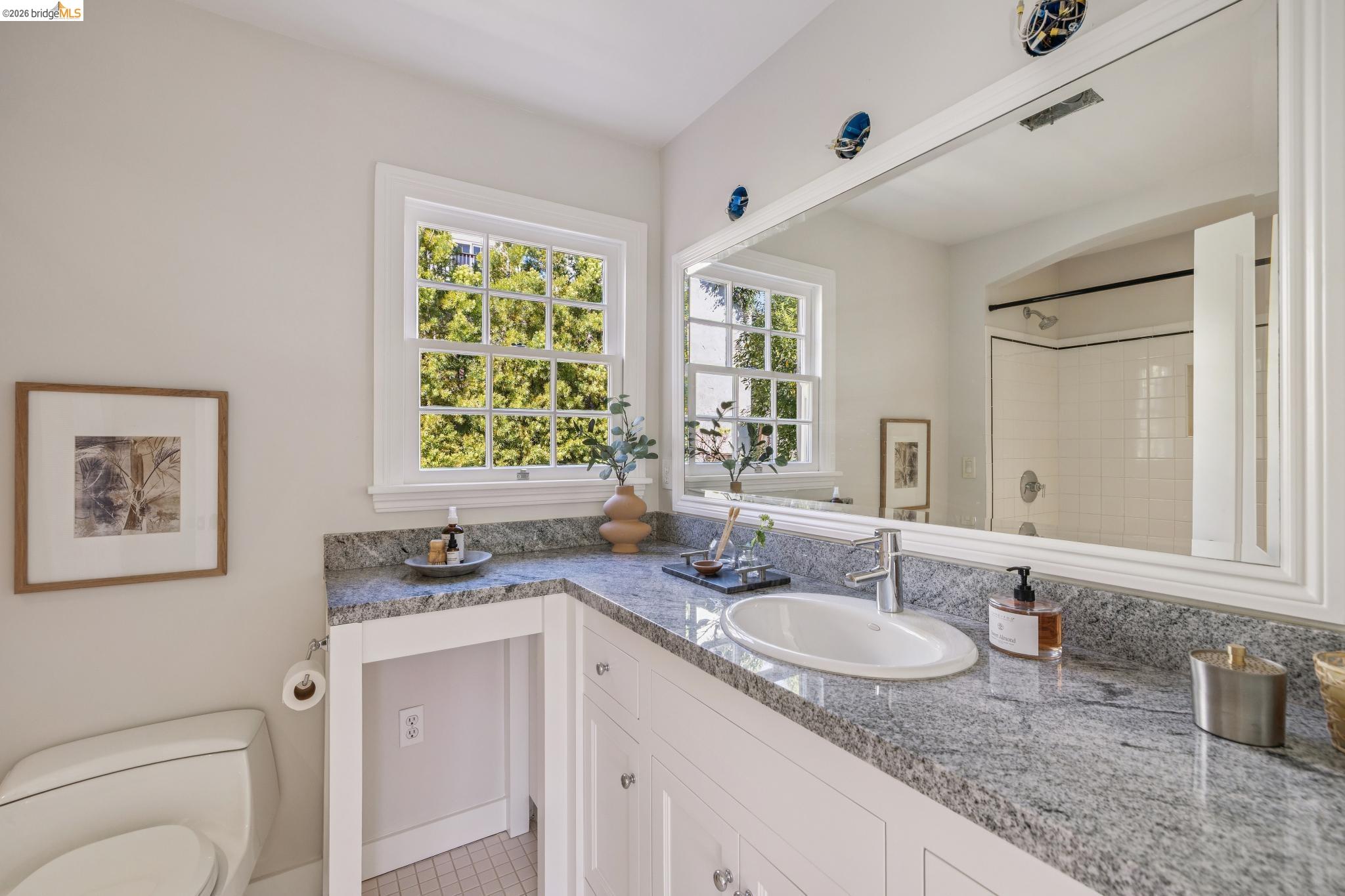 900 Rosemount Road Oakland, CA 94610 - Photo 46 of 59 a bathroom with a granite countertop sink and a mirror