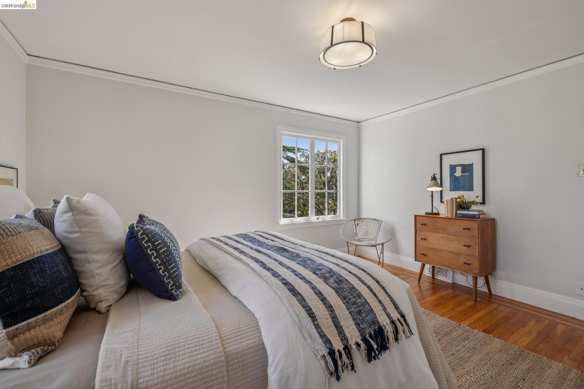 900 Rosemount Road Oakland, CA 94610 - Photo 53 of 59 a bedroom with a bed and chair with the wooden floor