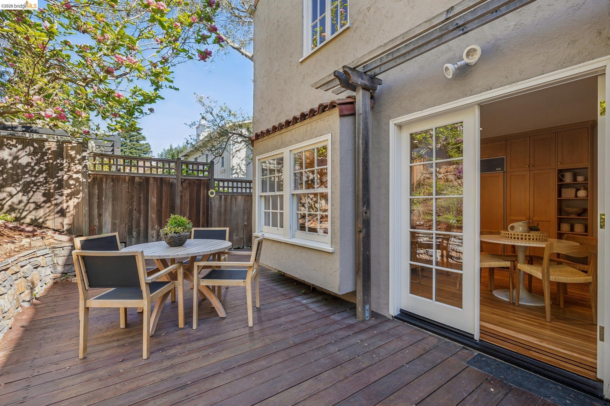 900 Rosemount Road Oakland, CA 94610 - Photo 55 of 59 a view of a deck with table and chairs and wooden floor