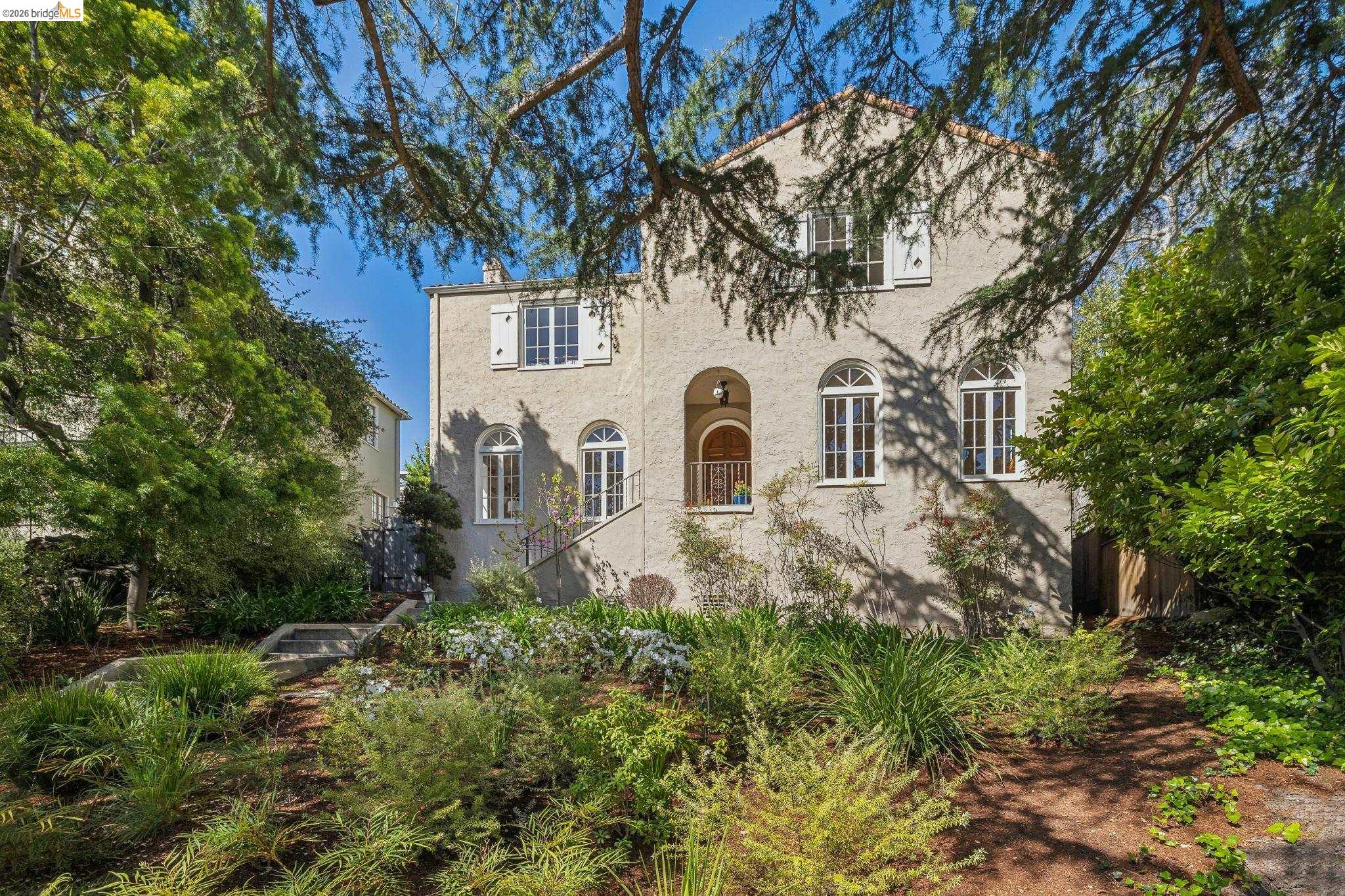 900 Rosemount Road Oakland, CA 94610 - Photo 7 of 59 a view of a white house with large trees