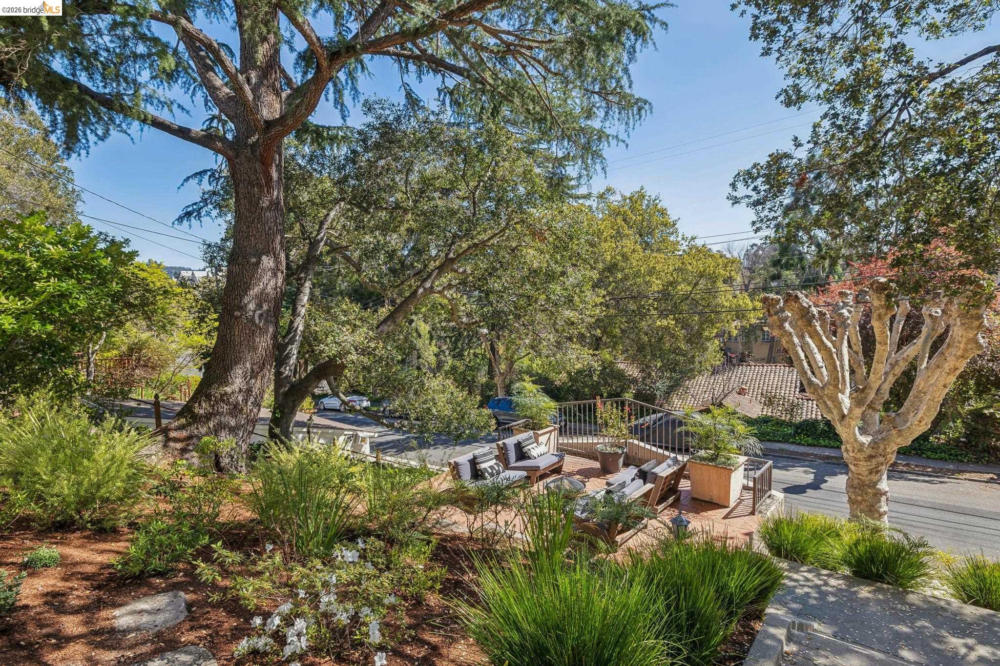 900 Rosemount Road Oakland, CA 94610 - Photo 8 of 59 a backyard of a house with lots of green space and fountain