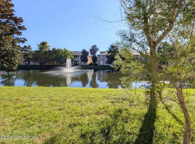 a view of a lake with a house in the background