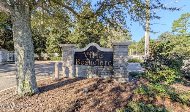 front view of a house with a large tree
