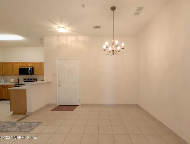 a view of a kitchen with microwave and cabinets