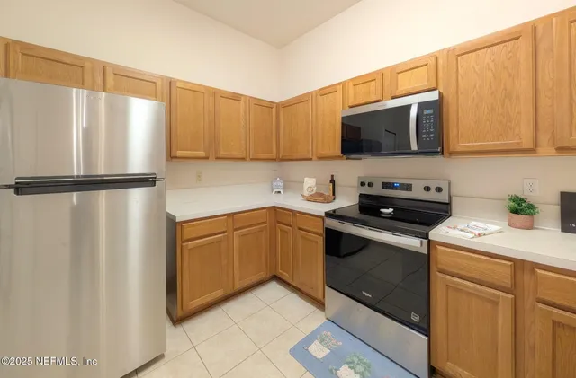 a kitchen with stainless steel appliances granite countertop a refrigerator sink and microwave